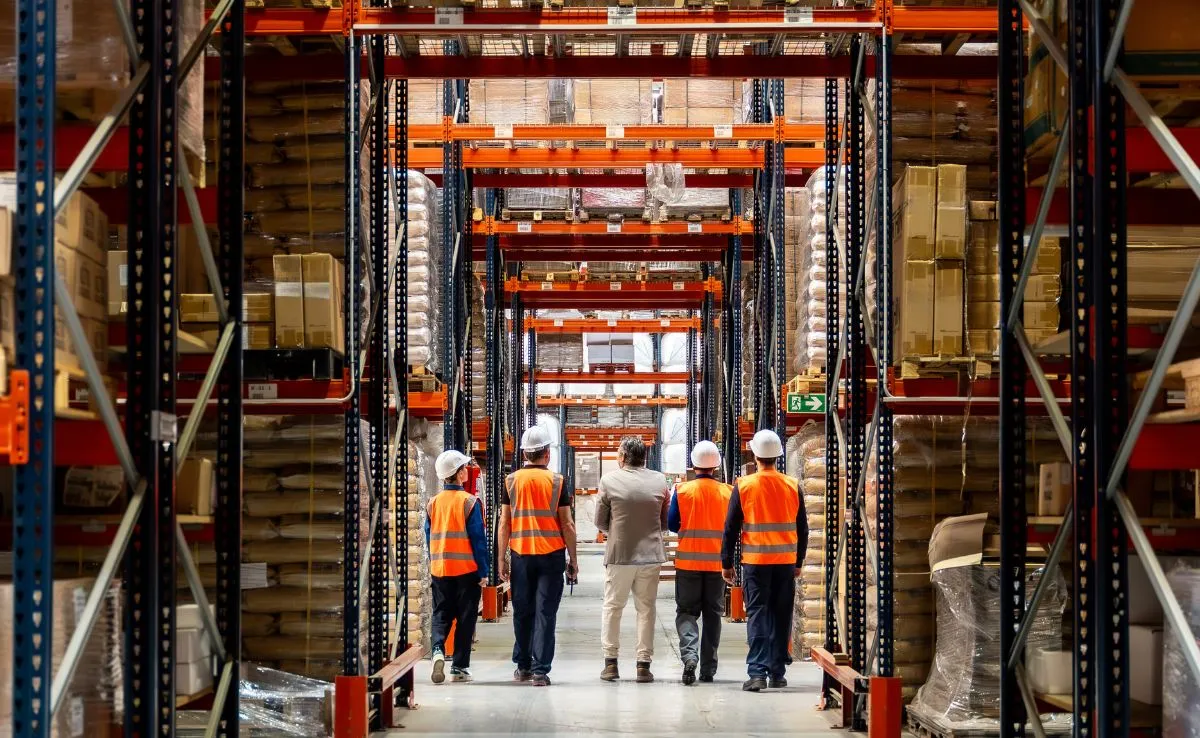 Warehouse workers conducting inventory check at an independent pharmacy distributor.